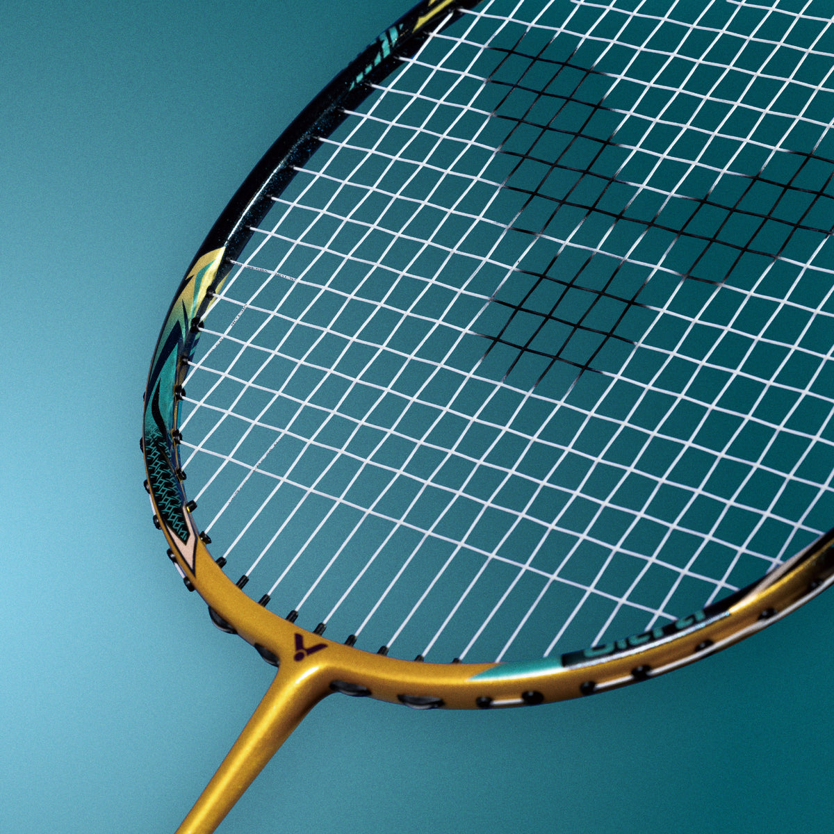 Close-up of a gold Victor badminton racket head
